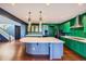 Open concept kitchen with a large island and green cabinets at 3438 Cade Ct, Castle Rock, CO 80104