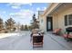 Relaxing backyard patio with seating and grill in a snowy setting at 7394 S Scottsburg Way, Aurora, CO 80016