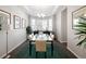 Elegant dining room with glass table and bay window at 7394 S Scottsburg Way, Aurora, CO 80016