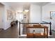 Light and airy entryway with hardwood floors, art, and console tables at 7394 S Scottsburg Way, Aurora, CO 80016