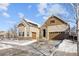 Two-story house with beige siding, brown accents, and a two-car garage at 7394 S Scottsburg Way, Aurora, CO 80016