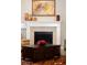 Modern fireplace with white mantel and stone surround at 7394 S Scottsburg Way, Aurora, CO 80016