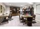 Bright home office with built-in bookshelves and a work table at 7394 S Scottsburg Way, Aurora, CO 80016