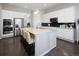 Modern kitchen with white cabinets, granite counters, and stainless steel appliances at 7394 S Scottsburg Way, Aurora, CO 80016