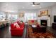 Living room with hardwood floors, fireplace, and red couches at 7394 S Scottsburg Way, Aurora, CO 80016