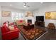 Bright living room with fireplace, hardwood floors, and comfortable seating at 7394 S Scottsburg Way, Aurora, CO 80016