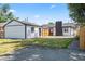 Backyard view of the home with modern white siding and a small patch of grass at 4645 E Florida Ave, Denver, CO 80222