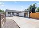 Exterior view of backyard showcasing a deck, patio and nice landscaping at 4645 E Florida Ave, Denver, CO 80222