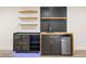 Modern bar area with wooden countertops, open shelves, black cabinets, and mini fridge at 4645 E Florida Ave, Denver, CO 80222