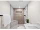 Modern bathroom featuring a stylish shower, gray tiles, with built-in bench and tiled floor at 4645 E Florida Ave, Denver, CO 80222