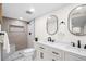 Modern bathroom with walk-in shower, double sinks with elegant white cabinetry and contemporary mirrors at 4645 E Florida Ave, Denver, CO 80222