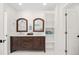 Bathroom features double sink vanity, wood framed mirrors, and ample storage with shelves at 4645 E Florida Ave, Denver, CO 80222