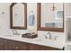 Close-up of bathroom vanity with double sinks, decorative mirrors, and modern fixtures at 4645 E Florida Ave, Denver, CO 80222