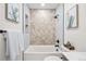 Bathroom showcasing tub with stylish herringbone tile, black fixtures, and modern decorations at 4645 E Florida Ave, Denver, CO 80222