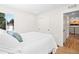 Comfortable bedroom featuring hardwood floors, a closet, and a bright window for natural light at 4645 E Florida Ave, Denver, CO 80222