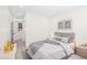 Cozy bedroom featuring a comfortable bed, neutral decor, and ample natural light from the windows at 4645 E Florida Ave, Denver, CO 80222
