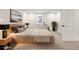 Bright bedroom featuring a wooden bed frame, soft rug, and minimalist decor for a calming atmosphere at 4645 E Florida Ave, Denver, CO 80222