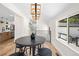 Cozy dining area with a round table, bar stools, modern lighting, and view into the kitchen at 4645 E Florida Ave, Denver, CO 80222