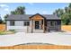Charming home featuring a striking black and white exterior and a welcoming covered porch entry at 4645 E Florida Ave, Denver, CO 80222