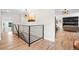 Hallway view features modern metal railing and a fireplace in an adjacent living area at 4645 E Florida Ave, Denver, CO 80222