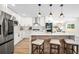Bright kitchen features an island with seating, modern stainless steel appliances, and pendant lighting at 4645 E Florida Ave, Denver, CO 80222