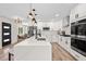 Bright modern kitchen with an island, stainless steel appliances, and stylish pendant lighting at 4645 E Florida Ave, Denver, CO 80222