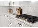 Kitchen featuring white marble countertops, white cabinets, and a built-in stovetop at 4645 E Florida Ave, Denver, CO 80222