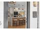 Beautiful kitchen featuring a center island with bar seating, pendant lighting, and modern appliances at 4645 E Florida Ave, Denver, CO 80222