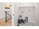 Well-lit laundry room with shelving, paint cans and tiled floor at 4645 E Florida Ave, Denver, CO 80222