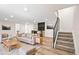 Cozy living room featuring modern furniture, decorative bar, and staircase with metal railings at 4645 E Florida Ave, Denver, CO 80222