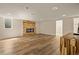 Large recreation room featuring wood-look flooring, fireplace, and a wooden bar at 4645 E Florida Ave, Denver, CO 80222