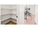 Open pantry featuring shelving, adjacent to an eat-in kitchen with a breakfast nook and bar stools at 4645 E Florida Ave, Denver, CO 80222