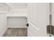 Spacious walk-in closet with built-in shelving and ample storage space, featuring neutral carpet at 4645 E Florida Ave, Denver, CO 80222