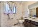 Cozy bathroom featuring a single sink vanity and patterned wall-paper at 661 S Paris St, Aurora, CO 80012