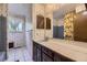 Full bathroom featuring a patterned wallpaper, a tub and shower combo and a single sink vanity at 661 S Paris St, Aurora, CO 80012