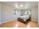 Bedroom features neutral walls, hardwood floors, and two windows for ample natural light at 661 S Paris St, Aurora, CO 80012