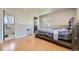 Bedroom with an adjacent bathroom, hardwood floors, neutral paint and a queen bed at 661 S Paris St, Aurora, CO 80012