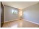 Simple bedroom with light-colored walls, hardwood floors, a small window, and closet at 661 S Paris St, Aurora, CO 80012