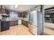 Traditional kitchen featuring wood cabinets, light countertops, and a stainless steel refrigerator at 661 S Paris St, Aurora, CO 80012