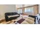 Bright living room with large windows, hardwood floors, and contemporary furniture and rug at 661 S Paris St, Aurora, CO 80012