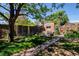Serene backyard features a well-manicured lawn, brick structure, and a wooden fence providing privacy at 433 Fox St, Denver, CO 80204