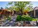 Picturesque backyard with a lush lawn, stone pathway, wooden fence, and a charming patio area at 433 Fox St, Denver, CO 80204