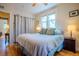 Bright bedroom with hardwood floors, large windows, and soft blue bedding creating a serene and inviting space at 433 Fox St, Denver, CO 80204