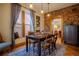 Charming dining room featuring exposed brick, a window seat, and a classic wooden table at 433 Fox St, Denver, CO 80204