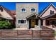 Charming two-story home featuring a bright yellow door and neat front yard landscaping at 433 Fox St, Denver, CO 80204