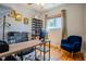 Bright home office with a large window, wooden desk, and stylish blue chair creating a productive and comfortable workspace at 433 Fox St, Denver, CO 80204