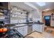 Well-organized kitchen with subway tile backsplash, sleek appliances, and open shelving at 433 Fox St, Denver, CO 80204