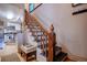 Elegant staircase with a wood banister, dark steps, and access to a bright kitchen, creating a warm, inviting atmosphere at 433 Fox St, Denver, CO 80204