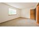 Bright bedroom with a large window and neutral carpet, perfect for relaxation at 1301 S Cathay Ct # 104, Aurora, CO 80017