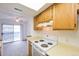 Efficient kitchen with wooden cabinets and sliding door to deck at 1301 S Cathay Ct # 104, Aurora, CO 80017